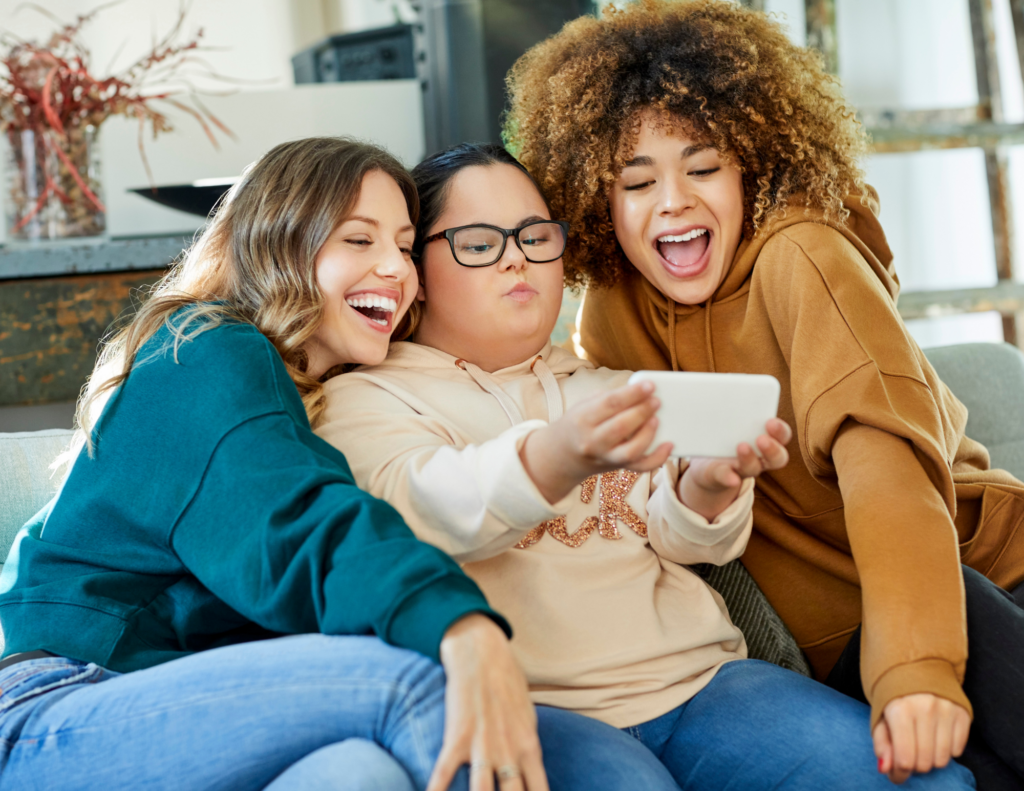 disable woman taking selfie with friends on sofa
